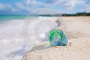 Glass tropical sea shell with waves under sun light