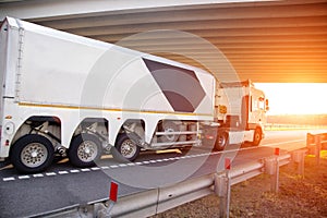 A glass truck with a special semi-trailer transports a fragile cargo of glass and mirrors along the highway against the