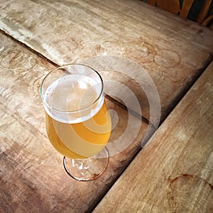 Glass of unfiltered beer on a bar table photo