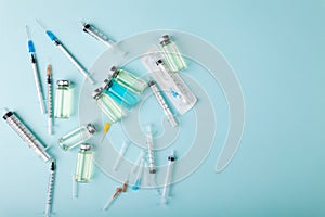 Glass vaccine ampoules, bottles, syringes, needles, top view