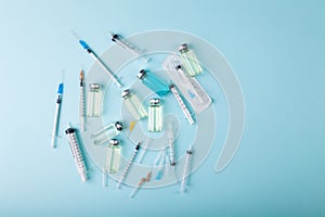 Glass vaccine ampoules, bottles, syringes, needles, top view