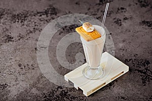 Glass of vanilla milkshake with whipped cream