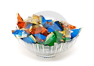 Glass vase with candy in colorful wrappers