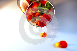 Glass vase filled with red rose petals. Aromatherapy concept.