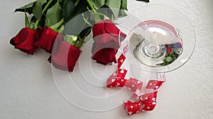 Glass with vermouth stading wrapped with red hearts ribbon