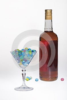 A glass for vermouth, water balls and a bottle