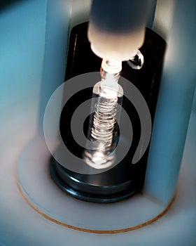 Glass vial being filled with medicine