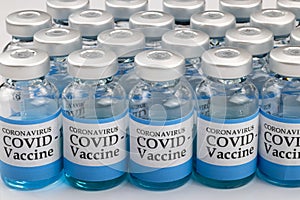 Glass vials labelled with COVID-19 text on white background