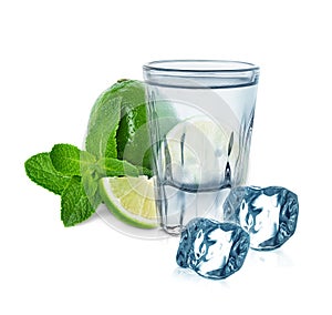 Glass of vodka with lime, mint and ice cubes