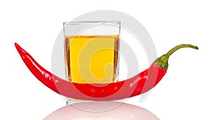 Glass vodka with red chili pepper isolated on white background.