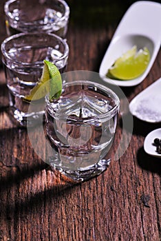 Glass of vodka shot with fresh lime