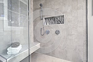 Glass walk-in shower in a bathroom of brand new home