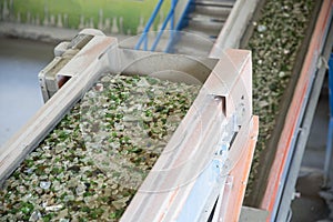 Glass waste in recycling facility. Glass particles in a machine