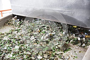 Glass waste in recycling facility. Glass particles in a machine