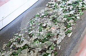Glass waste in recycling facility. Glass particles in a machine