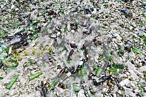 Glass waste in recycling facility. Pile of bottles.