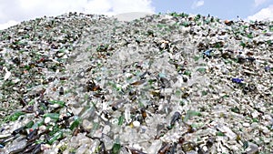 Glass waste in recycling facility. Pile of bottles. Zoom out.