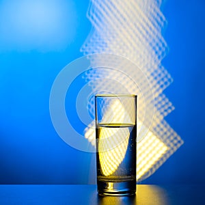 Glass of water on an abstract background