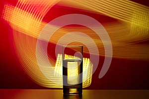 Glass of water on an abstract background