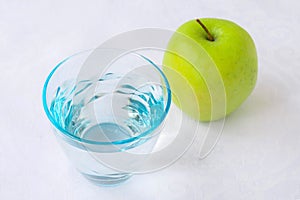 Glass of water and apple