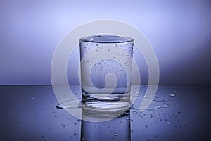 A glass with water on a blue background