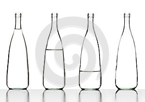Glass water bottles alienated from full to empty photo