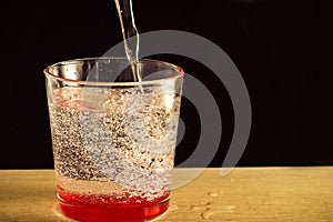 A glass of water with bubbles and splashes