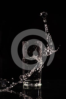 Glass of water on a dark background