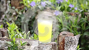 A glass of water with an effervescent vitamin tablet in nature
