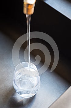 Glass of water filled at the tap