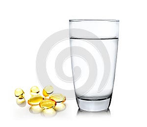 Glass of water and fish oil on white background