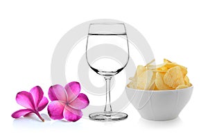 Glass of water frangipani flower , Bowl of potato chips