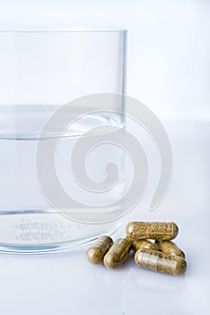 Glass of water with homepathy pills