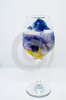 Glass of water with ice cubes isolated on white background,Butterfly pea or blue pea flower juice with lemon cool.