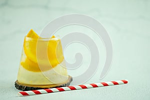 A glass of water with ice cubes and slices of fresh orange