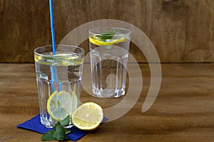 Glass of water with lime.summer drinks. two glasses of lemonade with lemon and fresh leafs mint