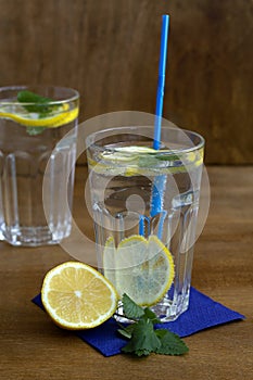 Glass of water with lime.summer drinks. two glasses of lemonade with lemon and fresh leafs mint