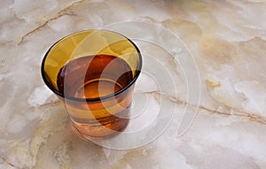 A glass of water on a marble table.