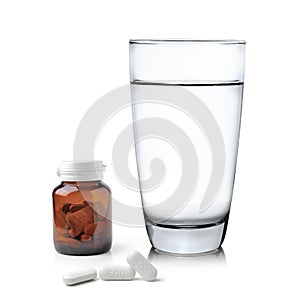 Glass of water Medicine bottle and pills