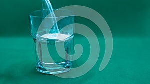 glass with water and medicine powders