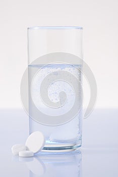 Glass of water mixed with pill