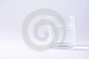Glass of water over grey background. Copy space. Water balance