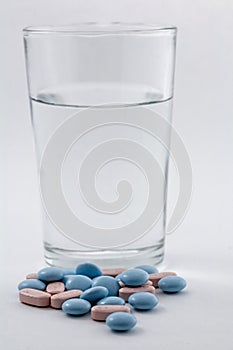 Glass of water and pills