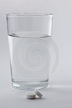 Glass of water and pills