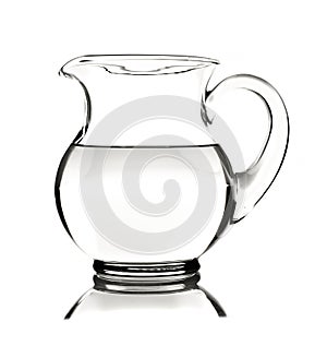 Glass water pitcher with water on white background