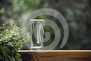 Glass of water put on table in the nature background