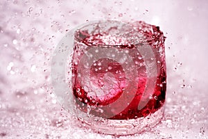 Red splashes in the glass of water