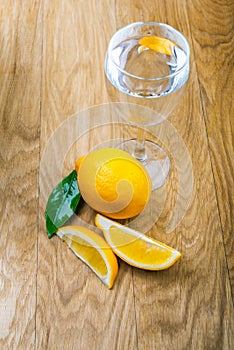 Glass of water and sliced fresh lemon