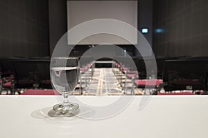 Glass of water on table at grand conference hall