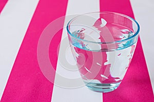 Glass of water on a tablecloth
